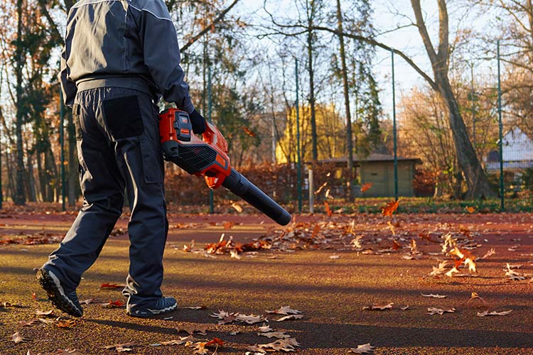Homem usa soprador para limpar exterior